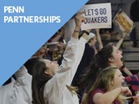 A group of enthusiastic sports fans cheering, with one holding a sign that reads "Let''s Go Quakers." The image has a blue overlay with the text "Penn Partnerships."